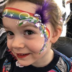 Rainbow face painting with bling