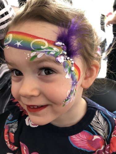 Rainbow face painting with bling